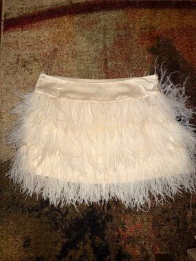 Bebe brand mini skirt is covered in fluffy ostrich feathers